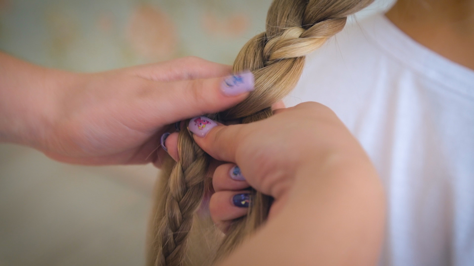 Девушка плетет косы